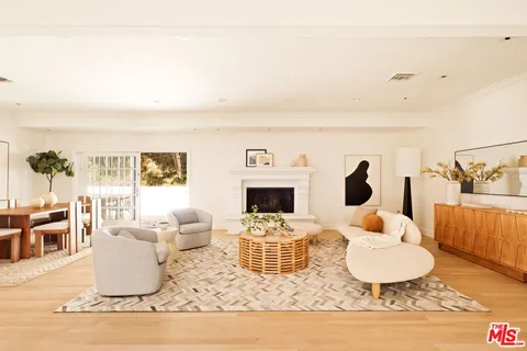 a living room with furniture a fireplace and a table