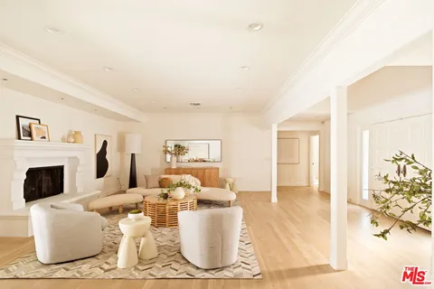 a living room with furniture a fireplace and a table