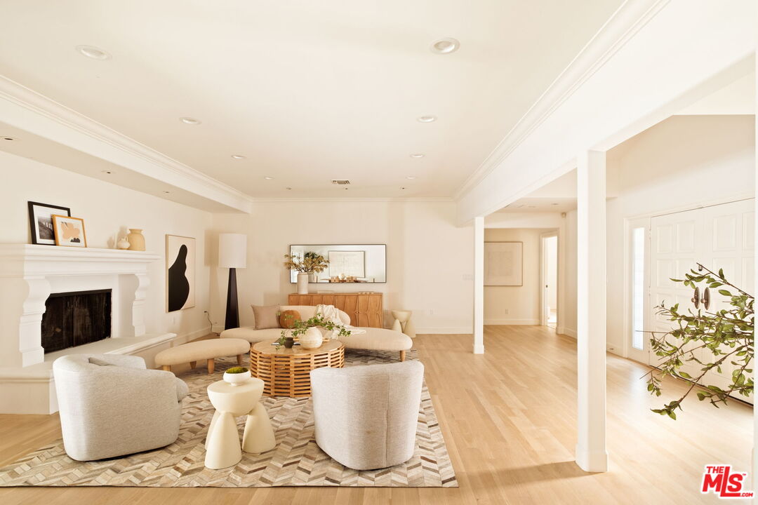 1132 Chantilly Road Los Angeles, CA 90077 - Photo 6 of 22 a living room with furniture a fireplace and a table