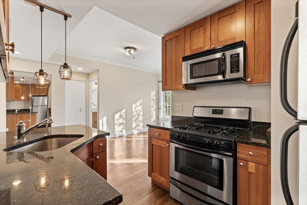 4420 North Ashland Avenue, Unit 3E Chicago, IL 60640 - Photo 8 of 15 a kitchen with stainless steel appliances a stove a microwave and a sink