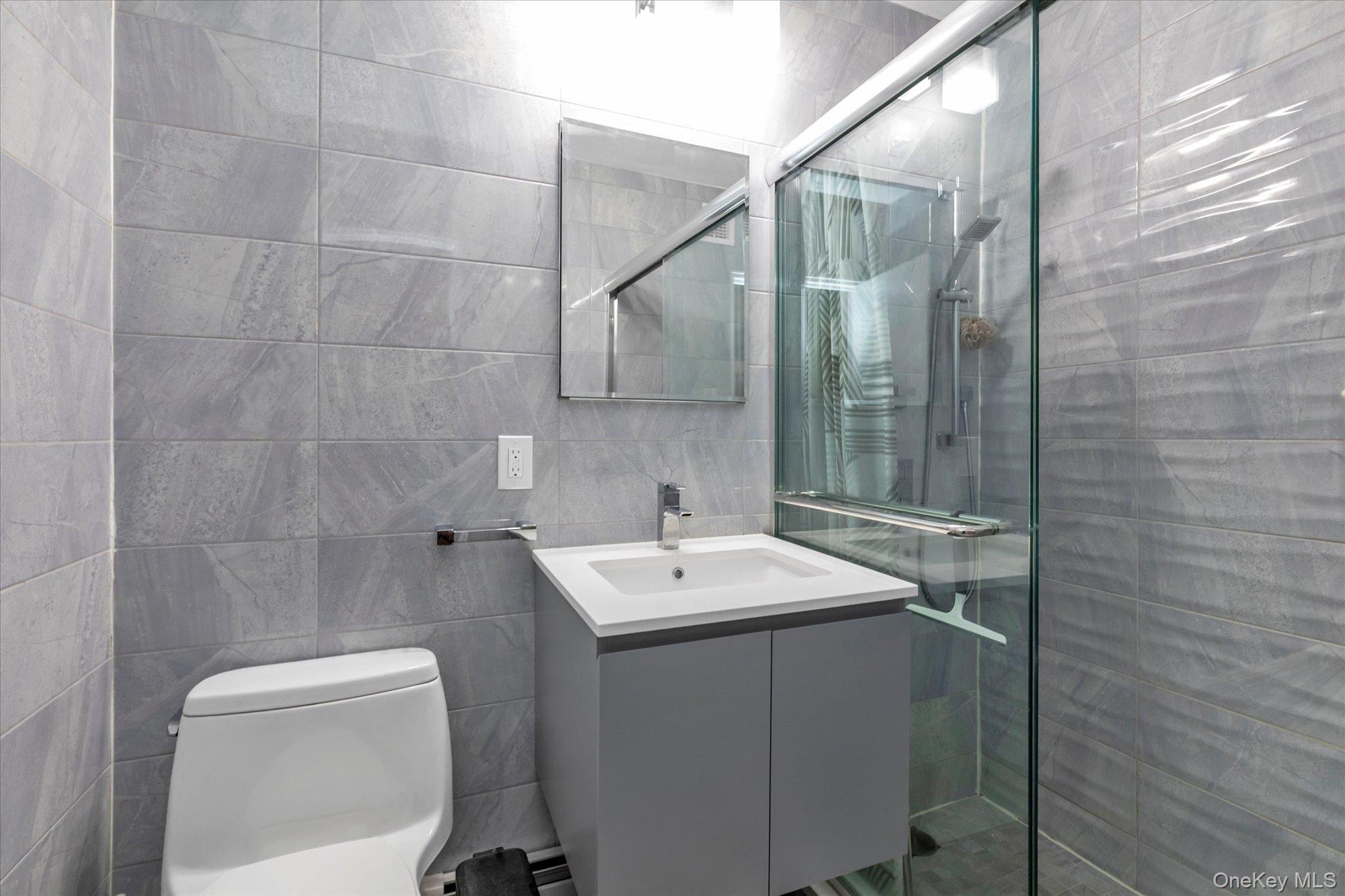 504 Merrick Road, Unit 3G Lynbrook, NY 11563 - Photo 9 of 19 Newly Renovated Full Bath with Floor to Ceiling Tile