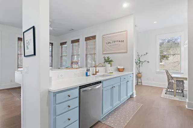 a spacious bathroom with a double vanity sink a mirror a bathtub and next to a window