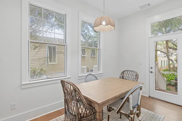 a view of a dining room with furniture a chandelier and wooden floor