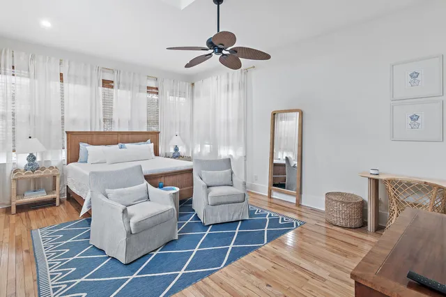 a living room with furniture a ceiling fan and a rug