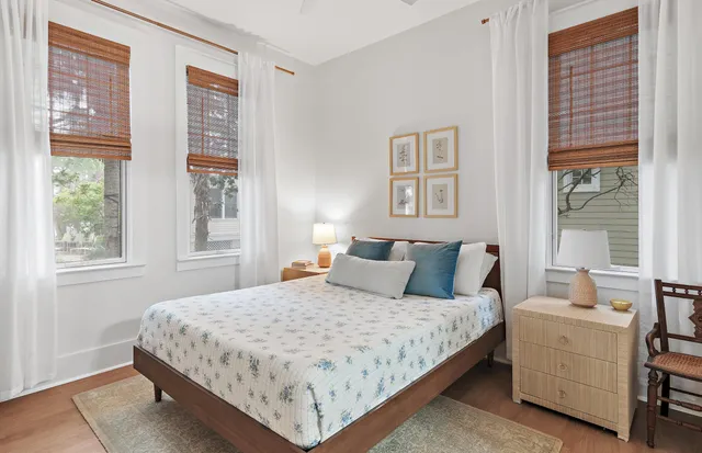 a bedroom with a large bed and windows