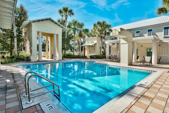 a view of a house with pool and sitting area