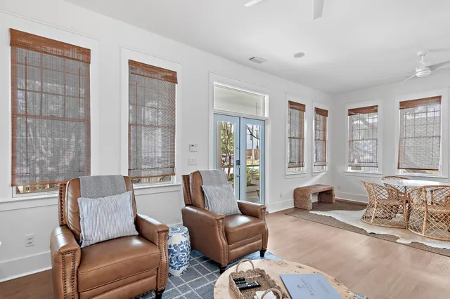 a living room with furniture and large windows