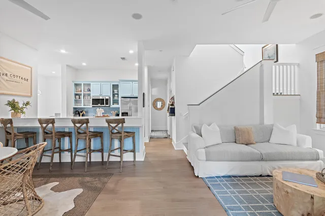 a living room with lots of furniture and a view of kitchen