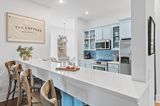 a kitchen with stainless steel appliances granite countertop a stove refrigerator and cabinets