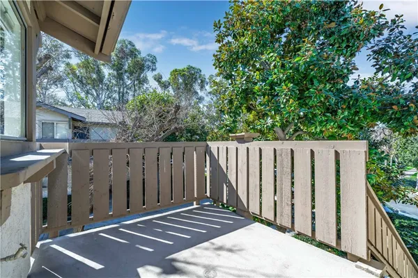 a view of backyard with wooden fence and trees