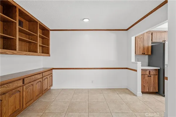 a kitchen with granite countertop a refrigerator and a stove