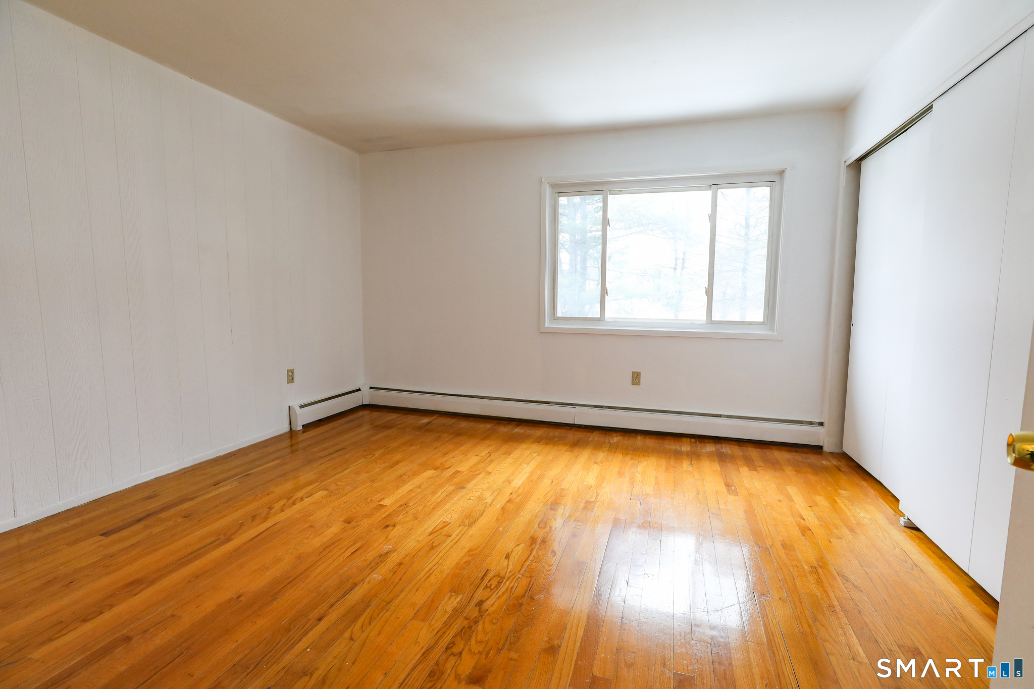 1 Camelot Drive, Unit 2 Bloomfield, CT 06002 - Photo 16 of 24 an empty room with wooden floor and windows