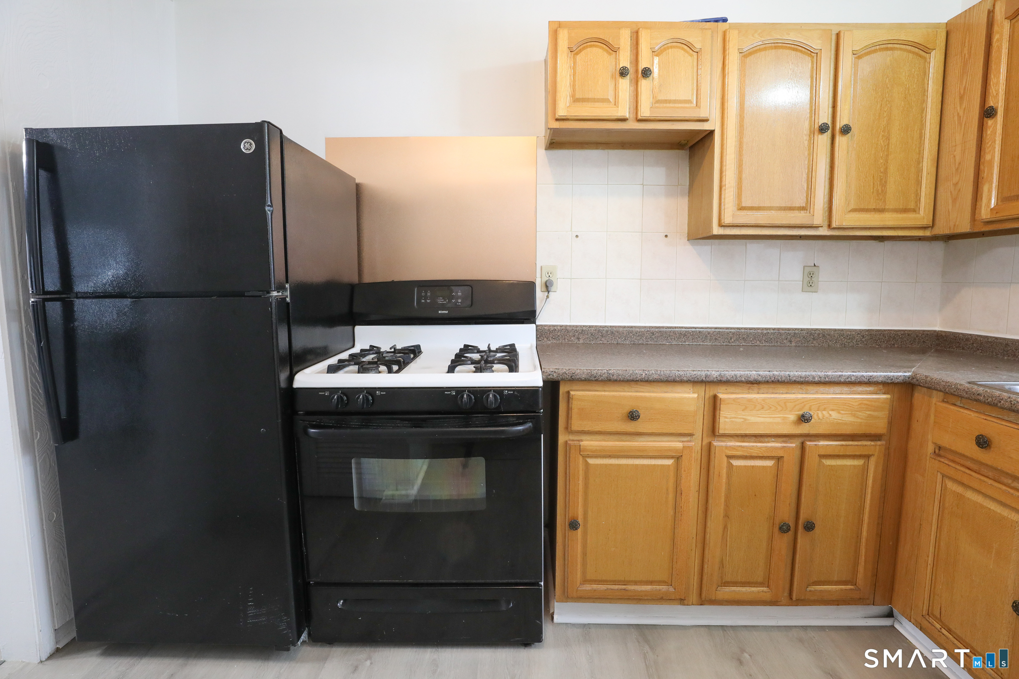 1 Camelot Drive, Unit 2 Bloomfield, CT 06002 - Photo 2 of 24 a kitchen with stainless steel appliances granite countertop a refrigerator and a stove