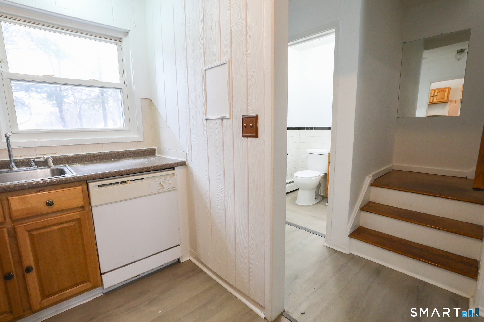 1 Camelot Drive, Unit 2 Bloomfield, CT 06002 - Photo 4 of 24 a view of a hallway with white cabinets and wooden floor
