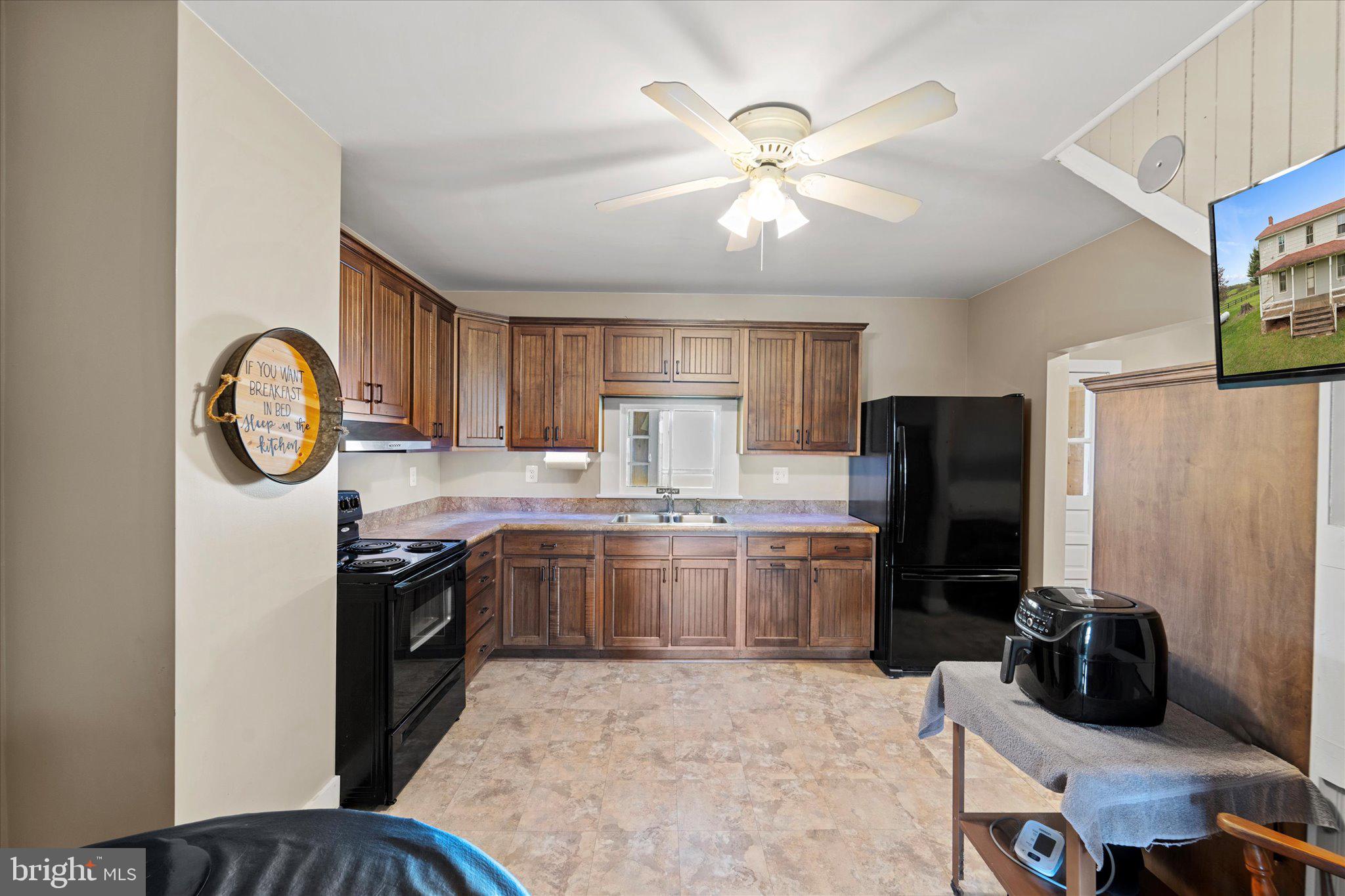 42880 Spinks Ferry Road Leesburg, VA 20176 - Photo 20 of 43 a kitchen with stainless steel appliances granite countertop a stove refrigerator a sink dishwasher with a dining table and chairs