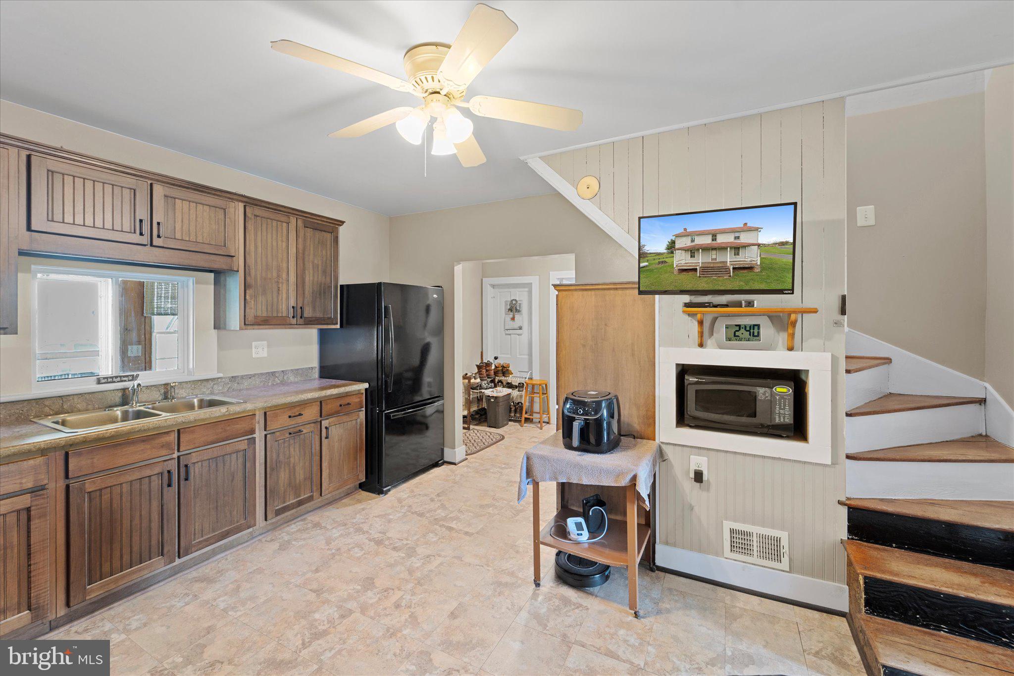 42880 Spinks Ferry Road Leesburg, VA 20176 - Photo 22 of 43 a kitchen with stainless steel appliances granite countertop a refrigerator a stove a sink dishwasher and white cabinets with wooden floor