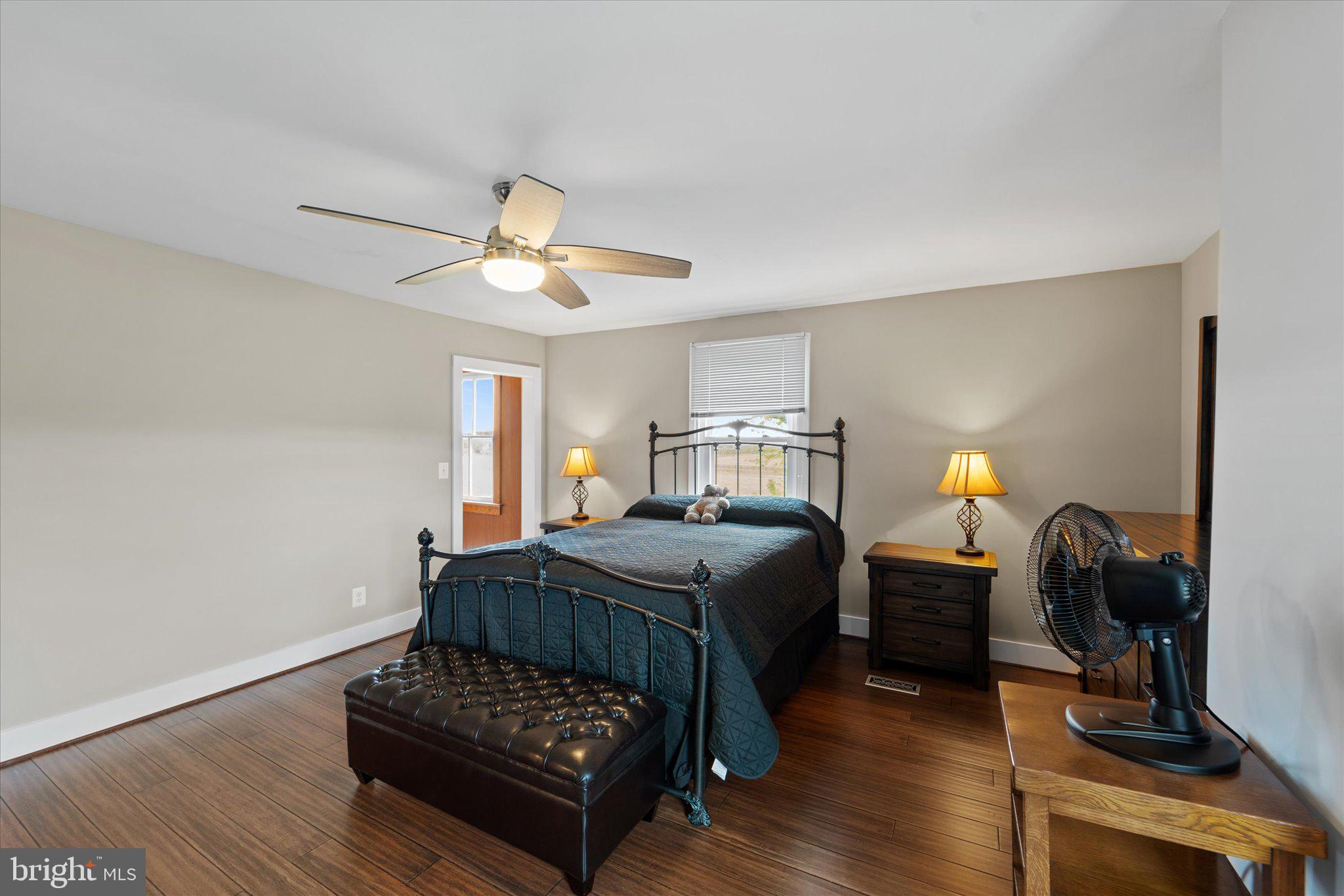 42880 Spinks Ferry Road Leesburg, VA 20176 - Photo 30 of 43 a bedroom with a bed and a chandelier