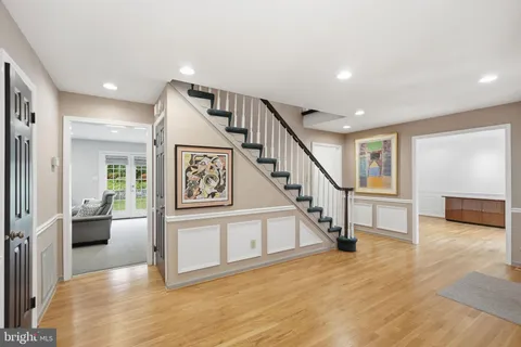 a view of entryway livingroom and hall with wooden floor