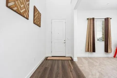 a view of front door with wooden floor
