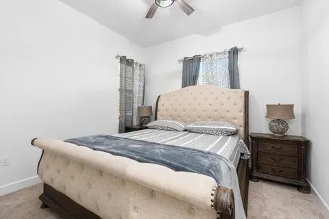 a bedroom with a bed and a chandelier