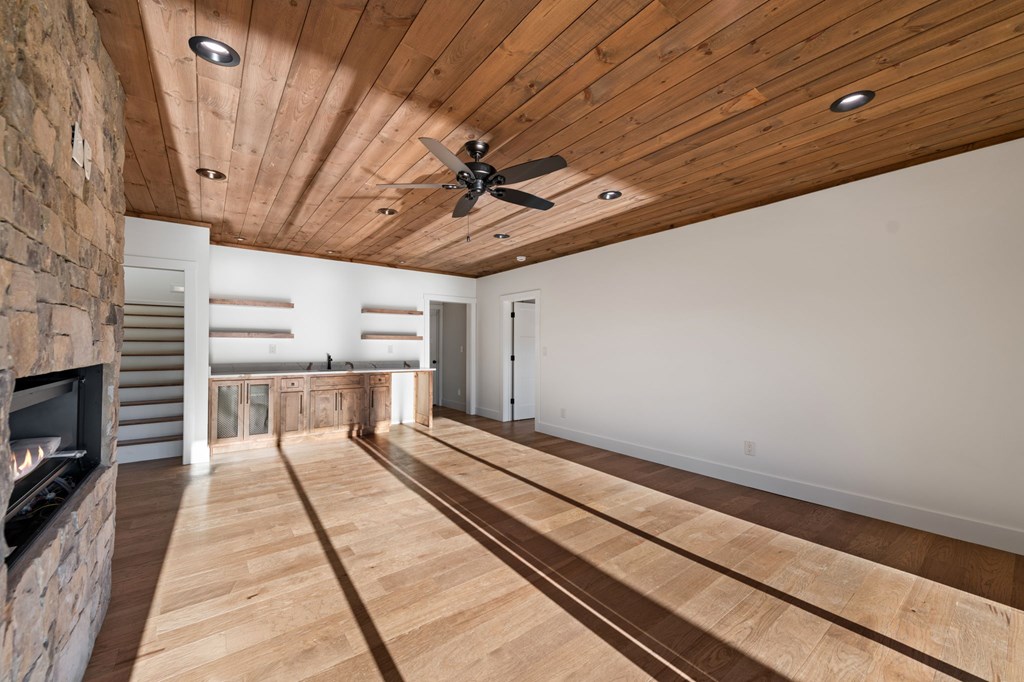 770 Fish Hook Point Blue Ridge, GA 30513 - Photo 53 of 96 2nd Lower Level Living Area, 2nd Lower Level features Full Wet Bar + Stained Ceilings + Gas Fireplace + Storage Behind Bar + Guest Bedroom 2, 3 & 4 + Full Bathroom w/ Walk In Shower | Slider Doors lead to deck & Lake Access