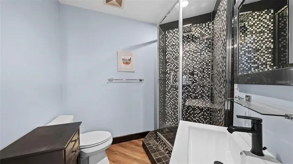 a bathroom with a toilet and a shower