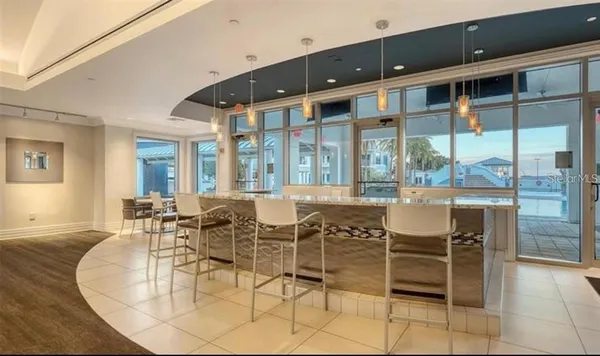 a dining room with furniture a chandelier and wooden floor