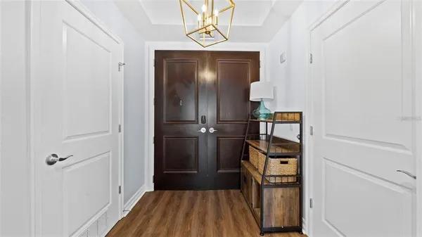 a view of a hallway with wooden floor and staircase
