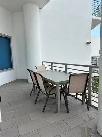 a view of a dining room with furniture and a window