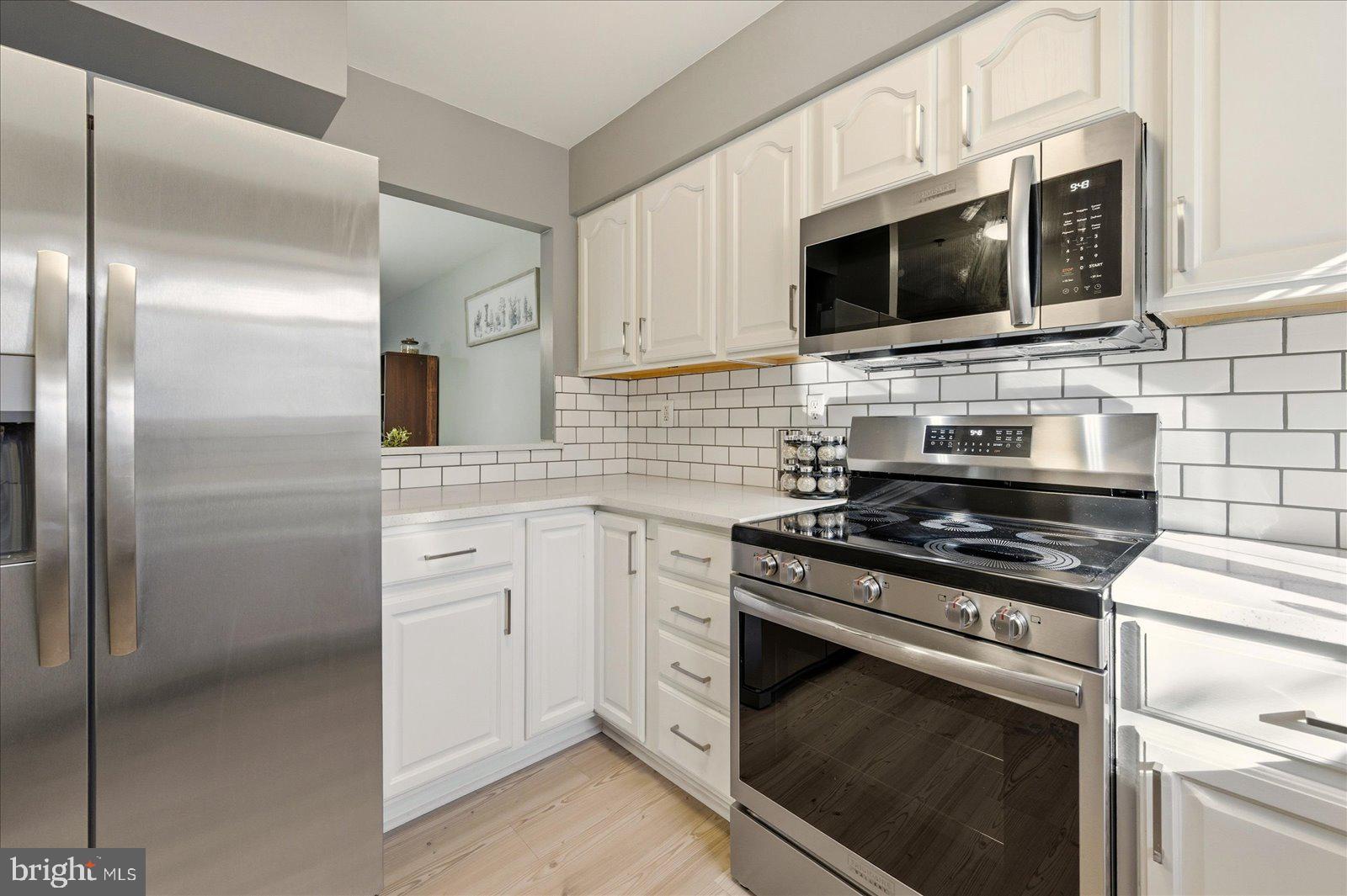 730 Canvasback Court Salisbury, MD 21804 - Photo 11 of 43 a kitchen with stainless steel appliances white cabinets a stove top oven a sink and dishwasher