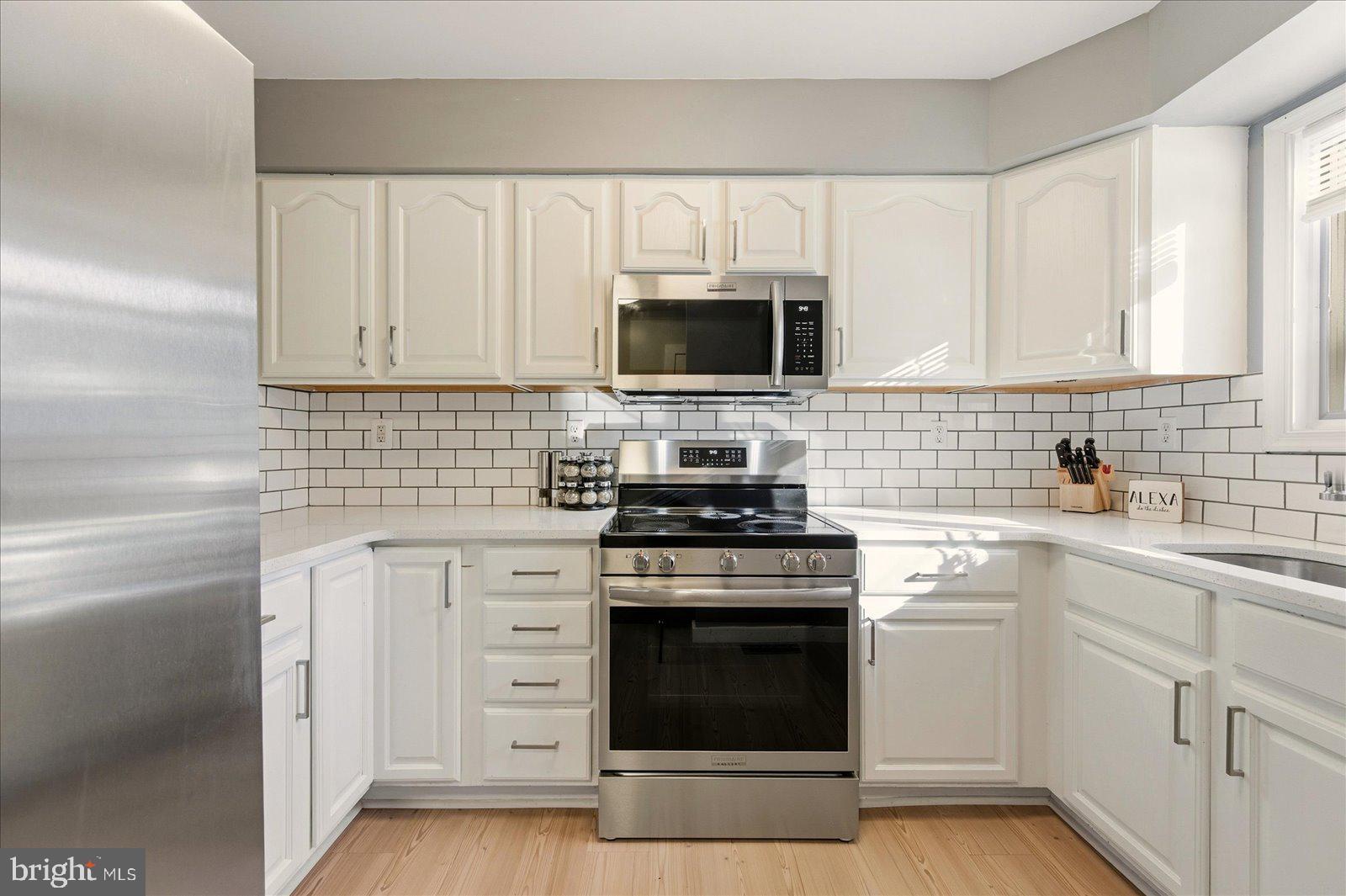 730 Canvasback Court Salisbury, MD 21804 - Photo 12 of 43 a kitchen with white cabinets stainless steel appliances and sink