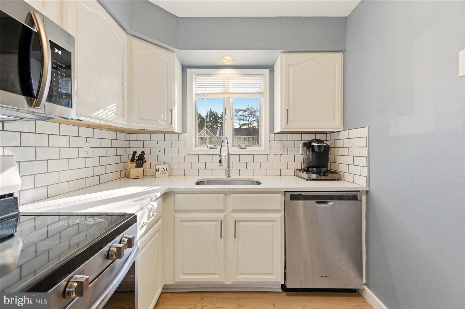 730 Canvasback Court Salisbury, MD 21804 - Photo 14 of 43 a kitchen with stainless steel appliances granite countertop a sink and a stove