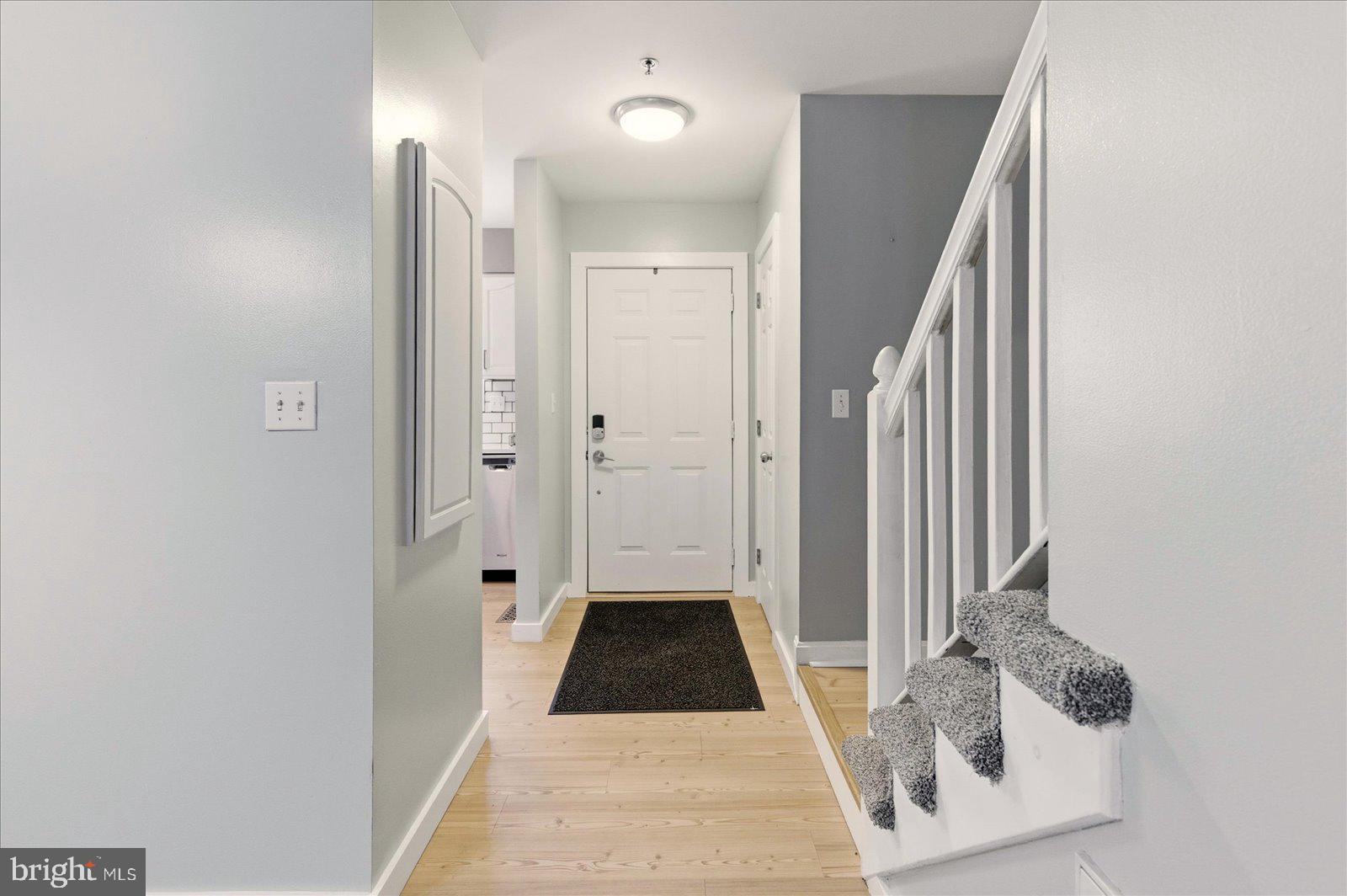 730 Canvasback Court Salisbury, MD 21804 - Photo 3 of 43 a view of a hallway with wooden floor and staircase
