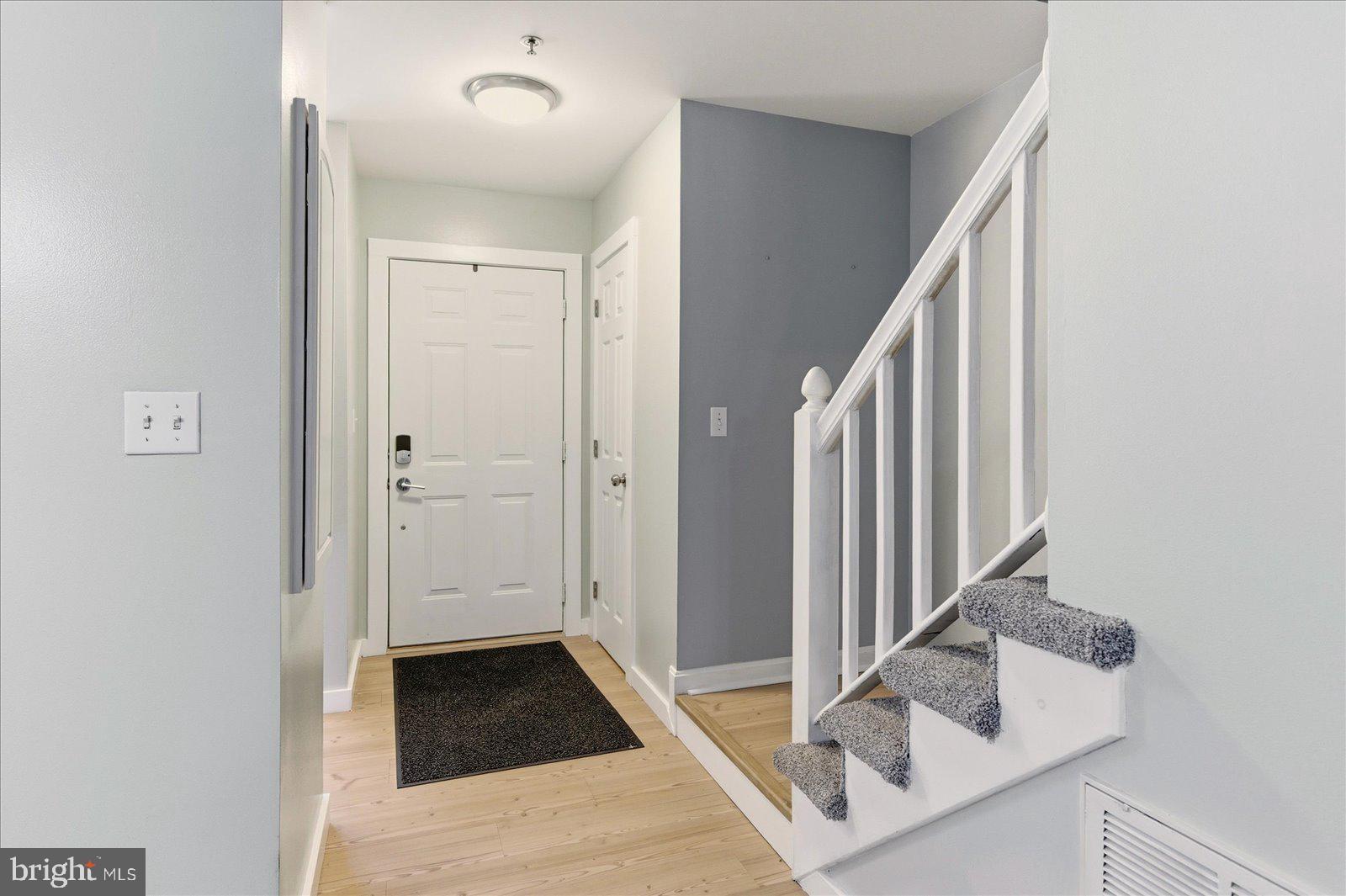 730 Canvasback Court Salisbury, MD 21804 - Photo 4 of 43 a view of a hallway with wooden floor and staircase