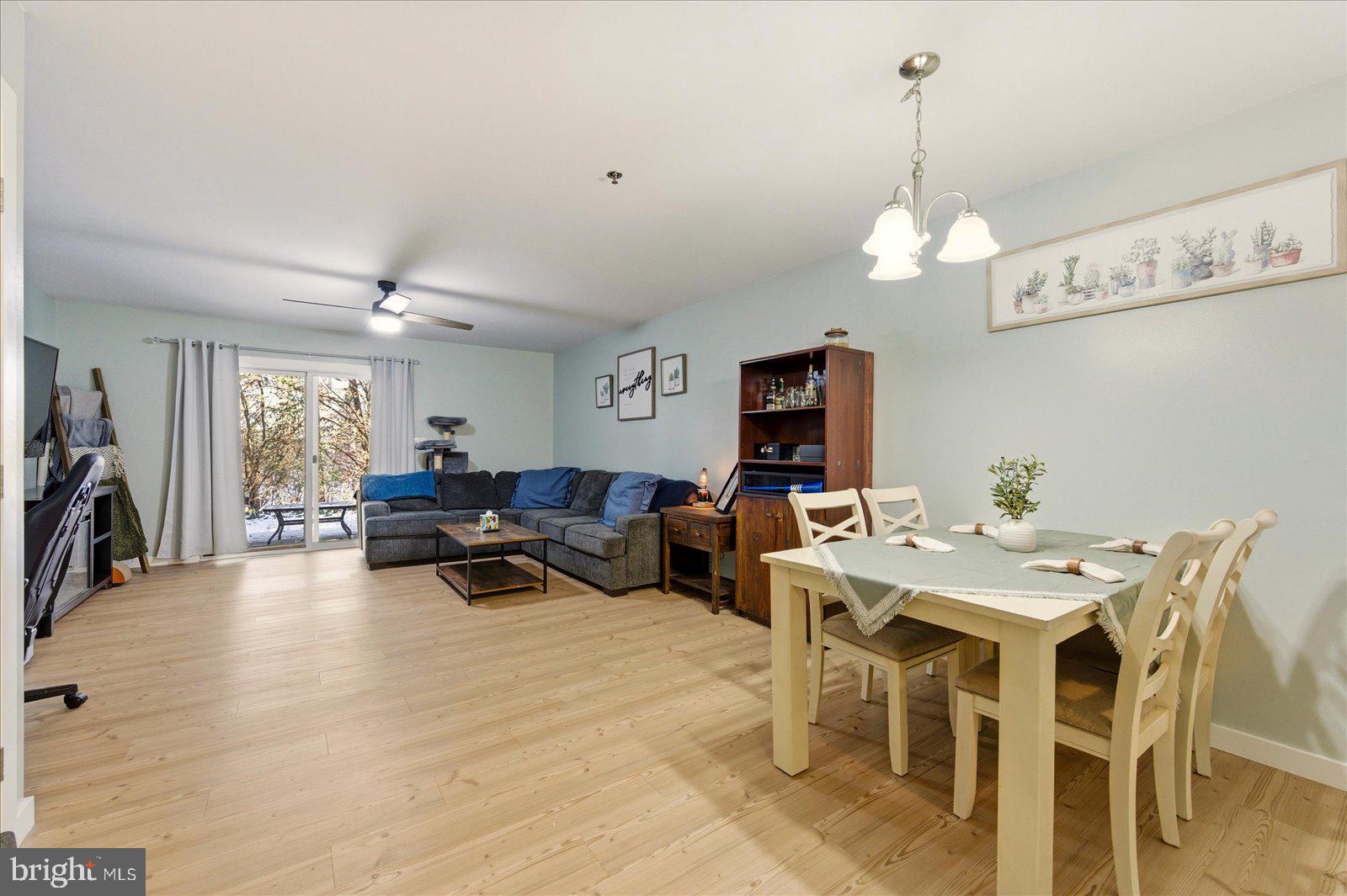 730 Canvasback Court Salisbury, MD 21804 - Photo 5 of 43 a view of a dining room and livingroom with furniture wooden floor a chandelier