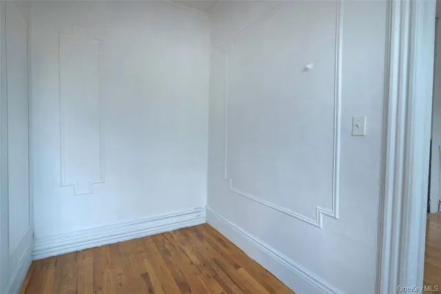 a view of a small space with wooden floor and closet