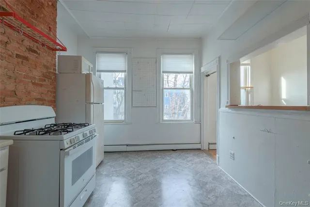 a kitchen with granite countertop a stove and a sink