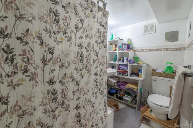 a bathroom with a toilet and a sink