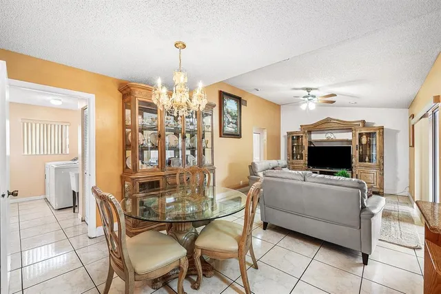 a view of a dining room with furniture and chandelier