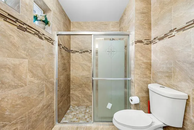 a bathroom with a toilet and a shower