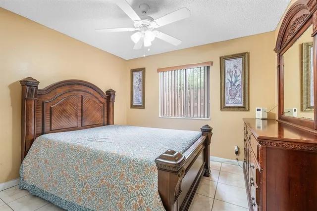 a bedroom with a bed dresser and a window