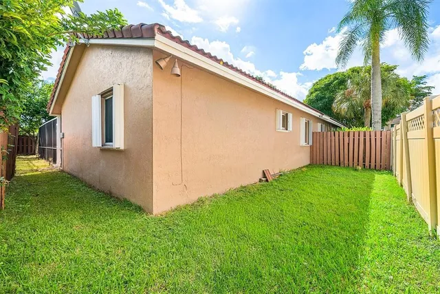 a view of backyard with garden and deck