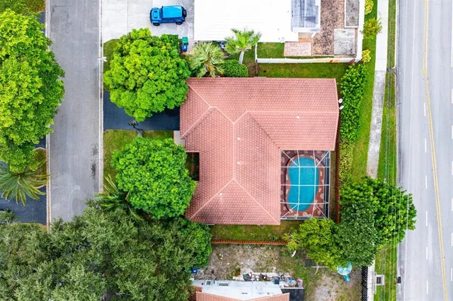 an aerial view of a house with garden space and a street view