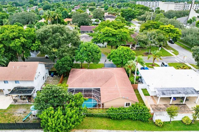 an aerial view of multiple houses with yard