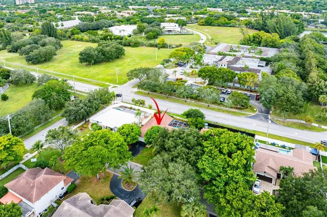 an aerial view of residential houses with outdoor space and street view