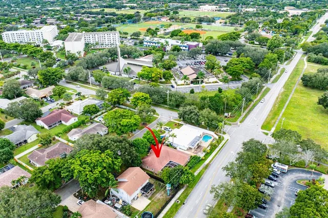 an aerial view of residential house with outdoor space and swimming pool
