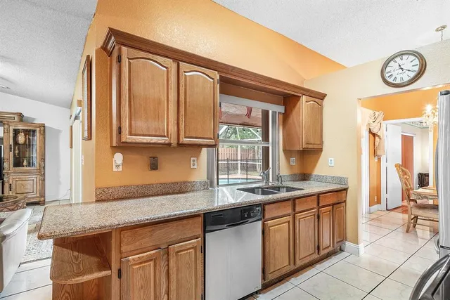 a kitchen with stainless steel appliances granite countertop a sink and a cabinets