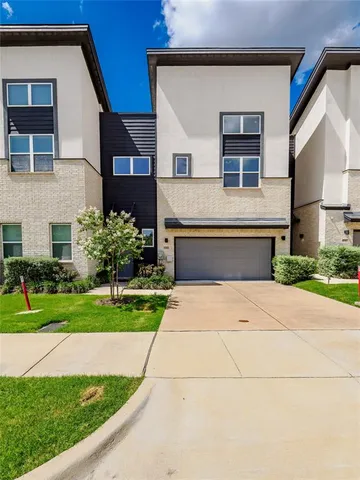 a front view of a house with a yard and a garage