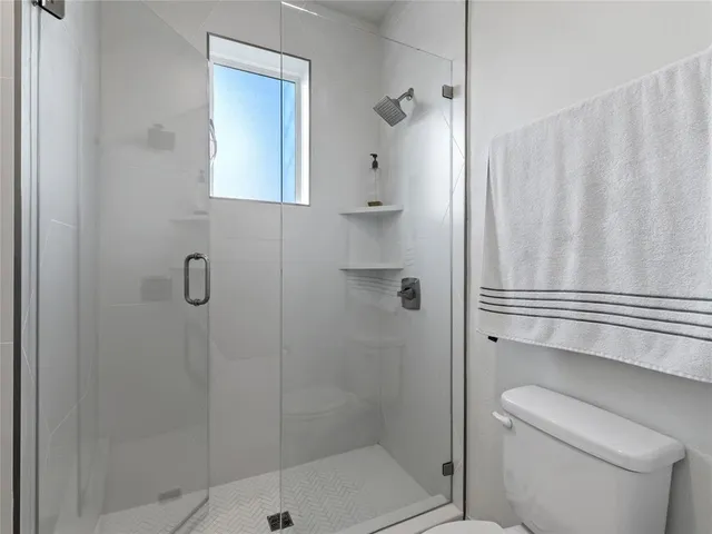 a bathroom with a shower and toilet