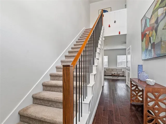 a view of entryway and hall with wooden floor
